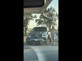 woman at a gas station in america